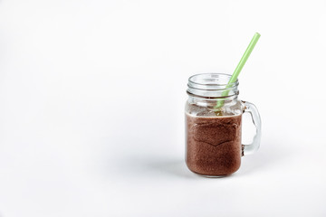 Cold chocolate milkshake in a glass jar with a straw.Fresh protein