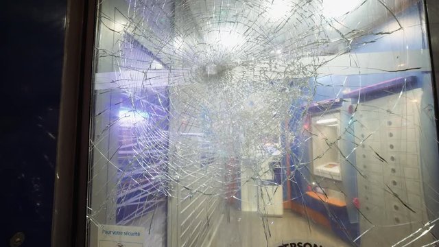 Bank branch entrance with shattered destroyed bulletproof glass at the entrance of ATM automatic teller machines