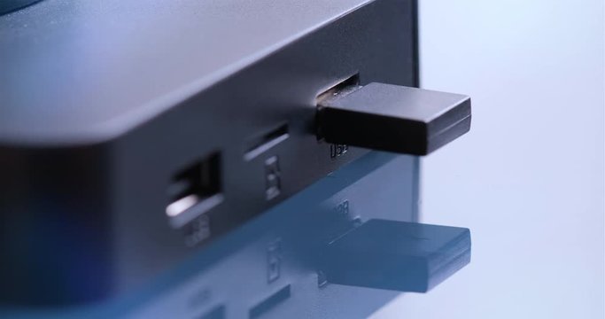 Hand holding USB air mouse to connect to device.