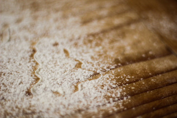 Ingredients for cooking Christmas baking: fir tree made from flour on a light table, kitchen utensils, top view.