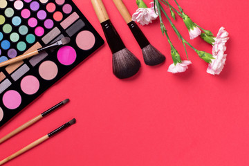 Set of cosmetics on color background with flowers.