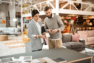 Attentive peaceful couple having conversation about furniture