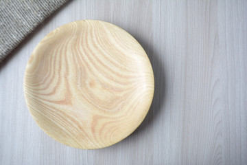 Empty wooden plate on the table Top view Kitchen decor Brown tones	