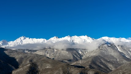 View of winter Caucasus Mountains and clouds from above, Krasnaya Polyana, Russia.
