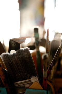 artists paint brushed in tin can