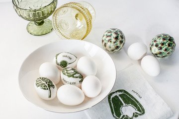 Easter eggs decorated with decoupage on a white background. Simple decoration of eggs with children