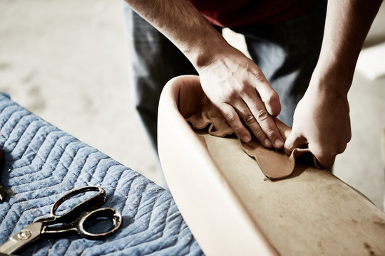craftsman hands working leather on upholstery - Powered by Adobe