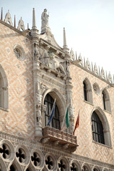 Ducal Palace with flags and winged lion statue. Symbol of the ci