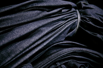 Bundle of blue denim tied with denim strap