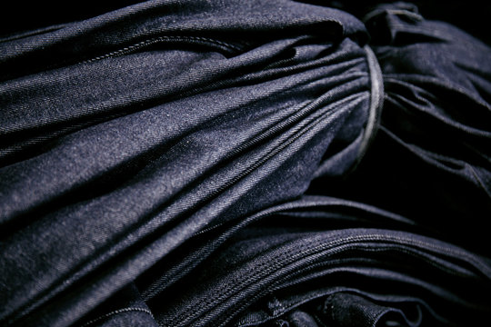 Bundle of blue denim tied with denim strap