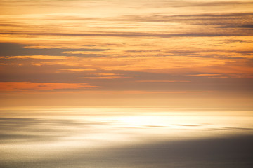 Obraz premium The sky and the sea are mixed in an orange color by sunset.
