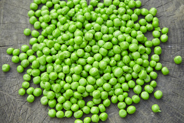 Green peas on a wooden  background