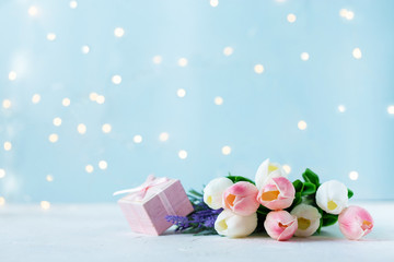 bouquet of tulips with bokeh lights on a blue background.