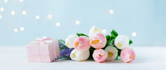 bouquet of tulips with bokeh lights on a blue background.