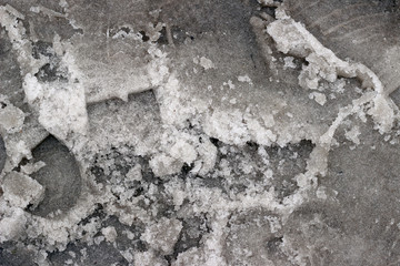 Melting snow asphalt slush water puddle flow dirty street sidewalk