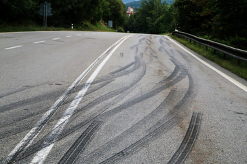 Fototapeta na wymiar The rubber tracks from the racing cars left on the tarmac at the start of the hill climb stage. 