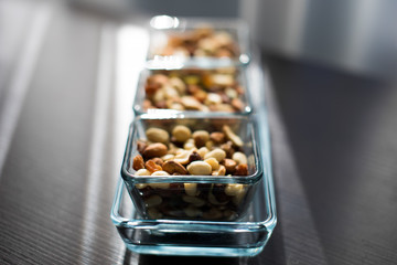 Raisins, peanuts and pistachio in elegant glass bowls