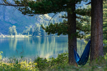 Russia, Siberia, Altay, Relax in hammock near lake
