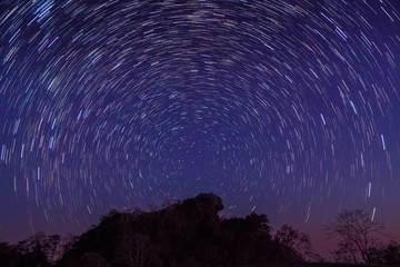 Fototapeta na wymiar Night photography of Star-Trails above Doi Hua Singh top of Doi Samur Dao, Sri Nan National Park, Nan, Thailand.
