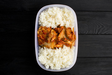 Kimchi and rice in the box on the  black wooden background.Top view.Copy space.