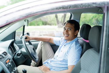 a man enjoying for time break inside a car