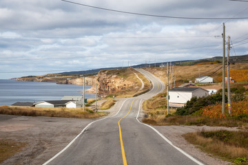 Scenic road on the Atlantic Ocean Coast during a vibrant sunny day. Taken in Felix Cove, Newfoundland, Canada.