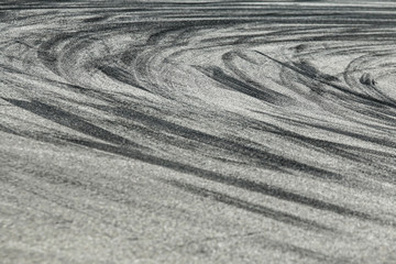 The rubber tracks from the rallye cars left on the tarmac in the hairpin. 