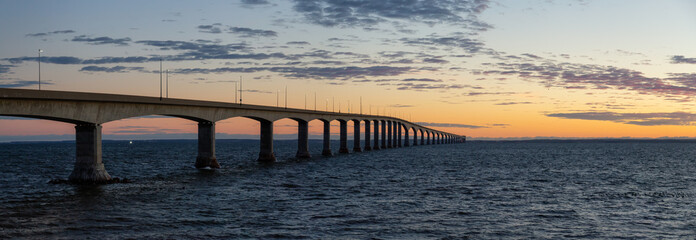 Panoramic view of Confederation Bridge to Prince Edward Island during a vibrant sunny sunrise....