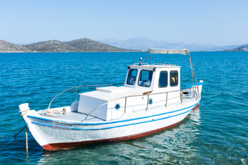 Naklejka na ściany i meble fishing boat at the pier in Crete