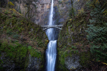 Beautiful view of a bridge going over a river with Multnomah Falls in the background. Located near Portland, Oregon, United States.