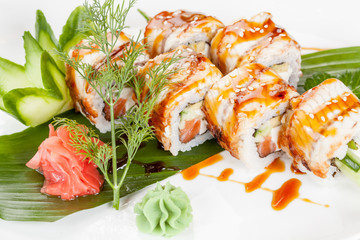 Japanese national popular cuisine. Sushi, rice and fish. Tasty, beautifully served food in a restaurant, cafe, with elements of the original design.