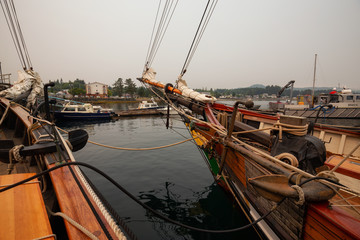 Port Hardy, Vancouver Island, BC, Canada - August 20, 2018: Wooden sailboat parked at a marina during a foggy summer day.