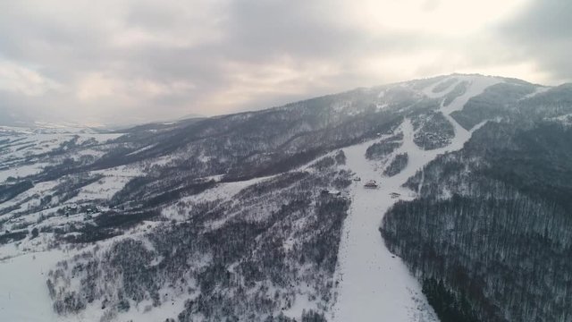 Epic Aerial Shot: Beautiful Winter Aerial Flight Over Mountains. Ski Vacation Travel. 4k