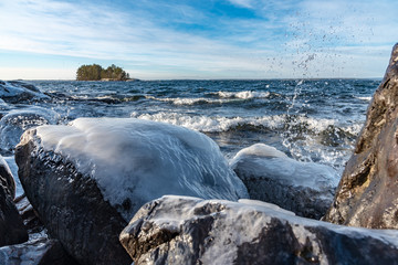 Icy stones on beach near lake Vattern 