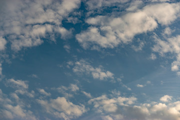 Winter clouds on a light blue sky. Background of clouds and the sky