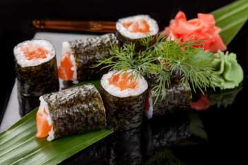Japanese national popular cuisine. Sushi, rice and fish. Tasty, beautifully served food in a restaurant, cafe, with elements of the original design.