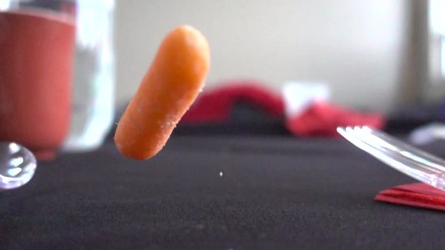 Slow Motion Carrot Bouncing And Falling On Table