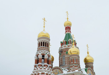 Fototapeta na wymiar winter urban landscape with snow from buildings and Orthodox Church