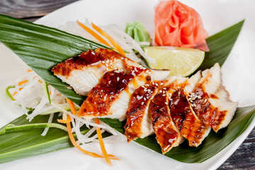 Japanese national popular cuisine. Sushi, rice and fish. Tasty, beautifully served food in a restaurant, cafe, with elements of the original design.
