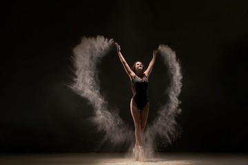 Fototapeta na wymiar Emotional dancer in flying white powder