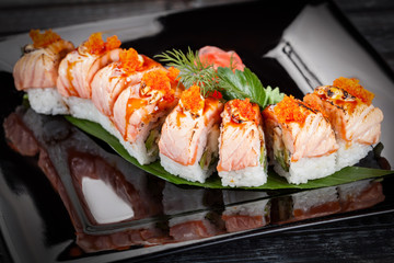 Japanese national popular cuisine. Sushi, rice and fish. Tasty, beautifully served food in a restaurant, cafe, with elements of the original design.