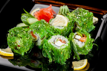 Japanese national popular cuisine. Sushi, rice and fish. Tasty, beautifully served food in a restaurant, cafe, with elements of the original design.