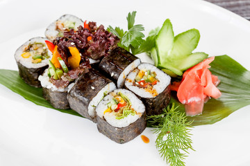 Japanese national popular cuisine. Sushi, rice and fish. Tasty, beautifully served food in a restaurant, cafe, with elements of the original design.