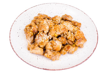 Plate with slices of chicken in batter with sesame seeds