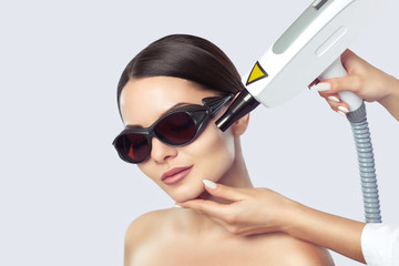 Carbon face peeling procedure in a beauty salon. Hardware cosmetology treatment.