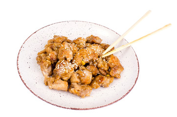 Plate with slices of chicken in batter with sesame seeds