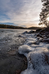 Icy stones on beach near lake Vattern 