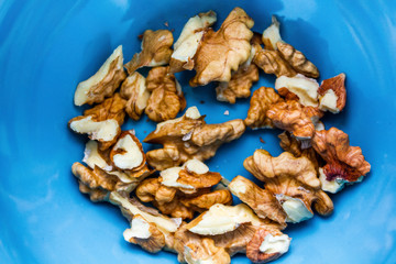 Close up of healthy brown walnuts scattered on the wooden table