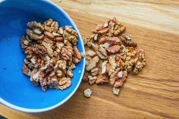 Close up of healthy brown walnuts scattered on the wooden table