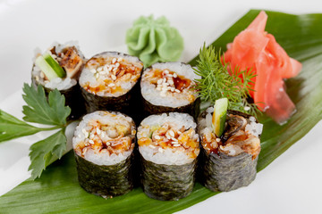 Japanese national popular cuisine. Sushi, rice and fish. Tasty, beautifully served food in a restaurant, cafe, with elements of the original design.